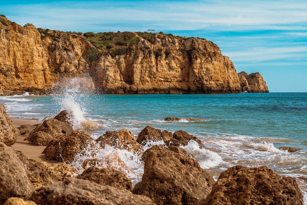 brown rock formation on sea during daytime