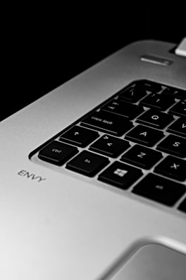 Close-up of hands typing on a laptop keyboard with sharpvista branding.