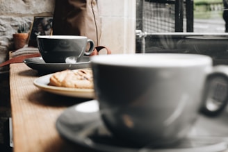 A cozy café setting with coffee cups on a table.