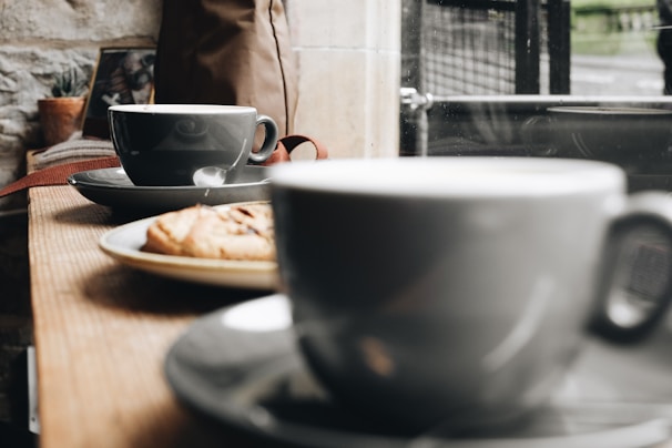 A cozy café setting with coffee cups on a table.