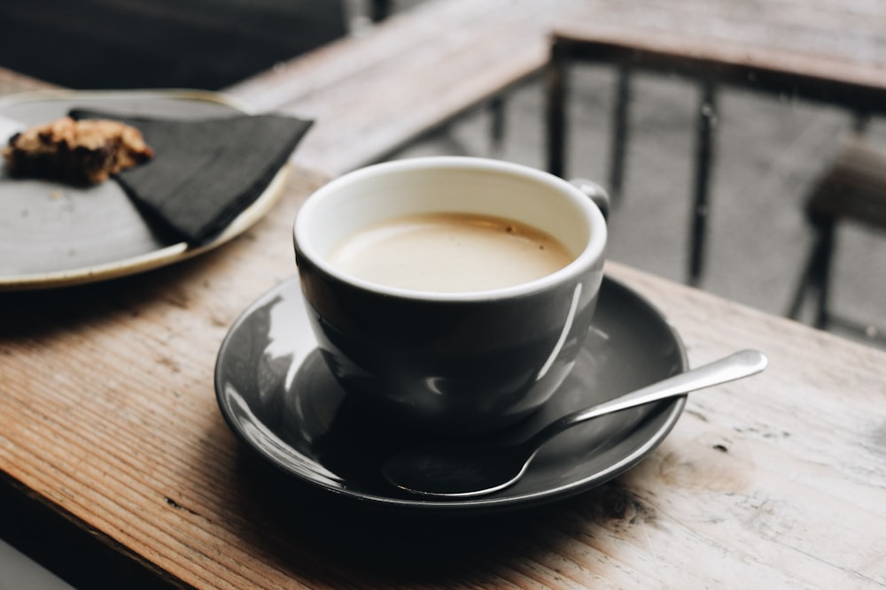 black ceramic mug on saucer