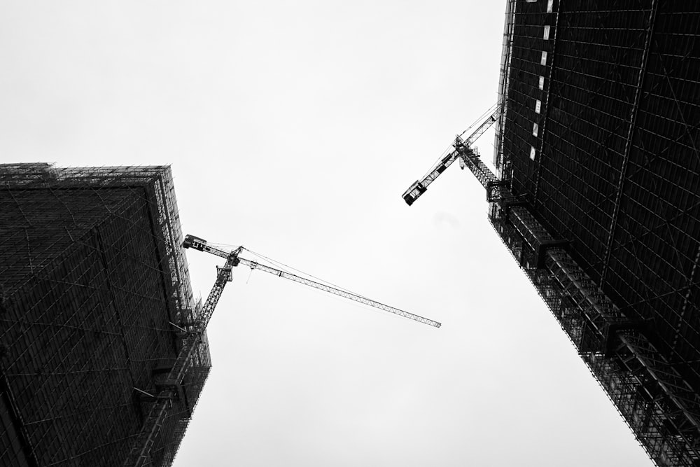 low angle photography of crane under cloudy sky during daytime