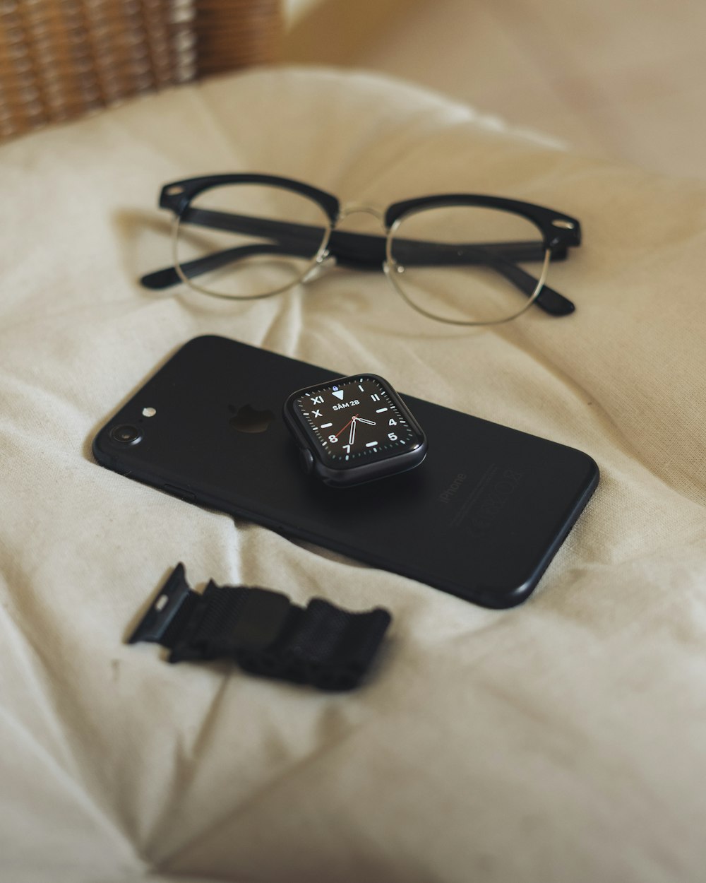 black iphone 4 on white textile
