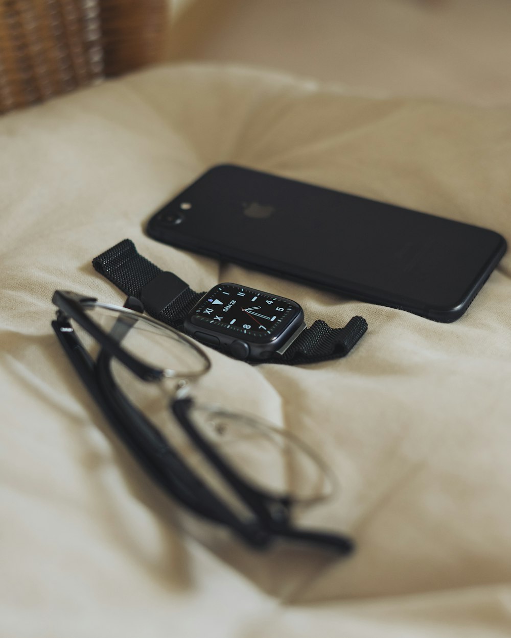 black smartphone beside black usb cable
