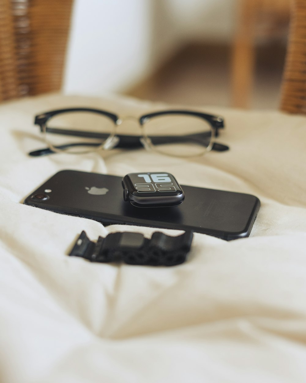 black framed eyeglasses on white textile