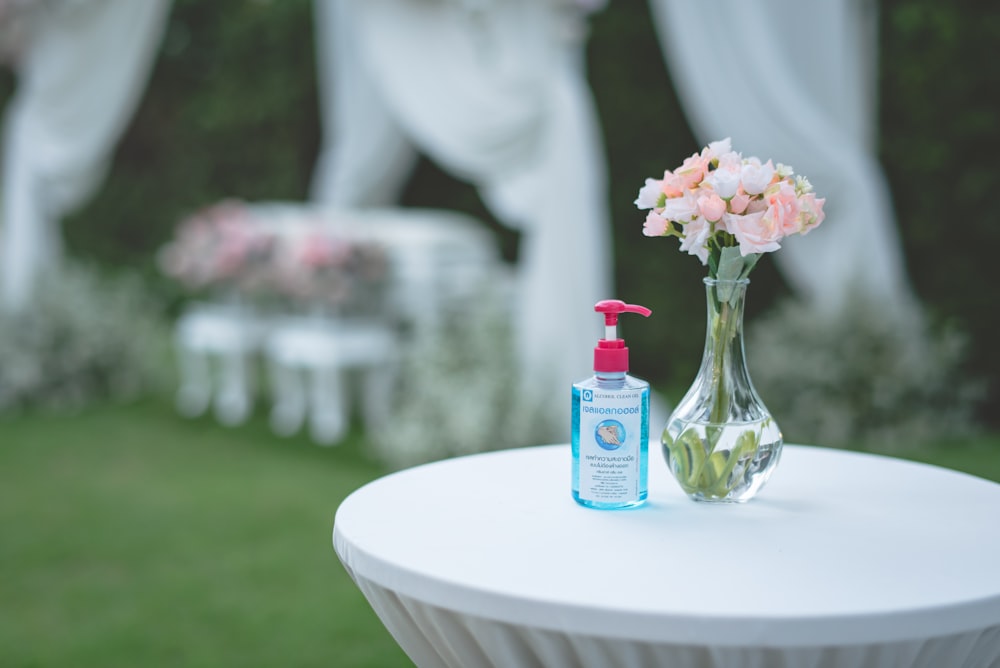 clear glass bottle on white round table