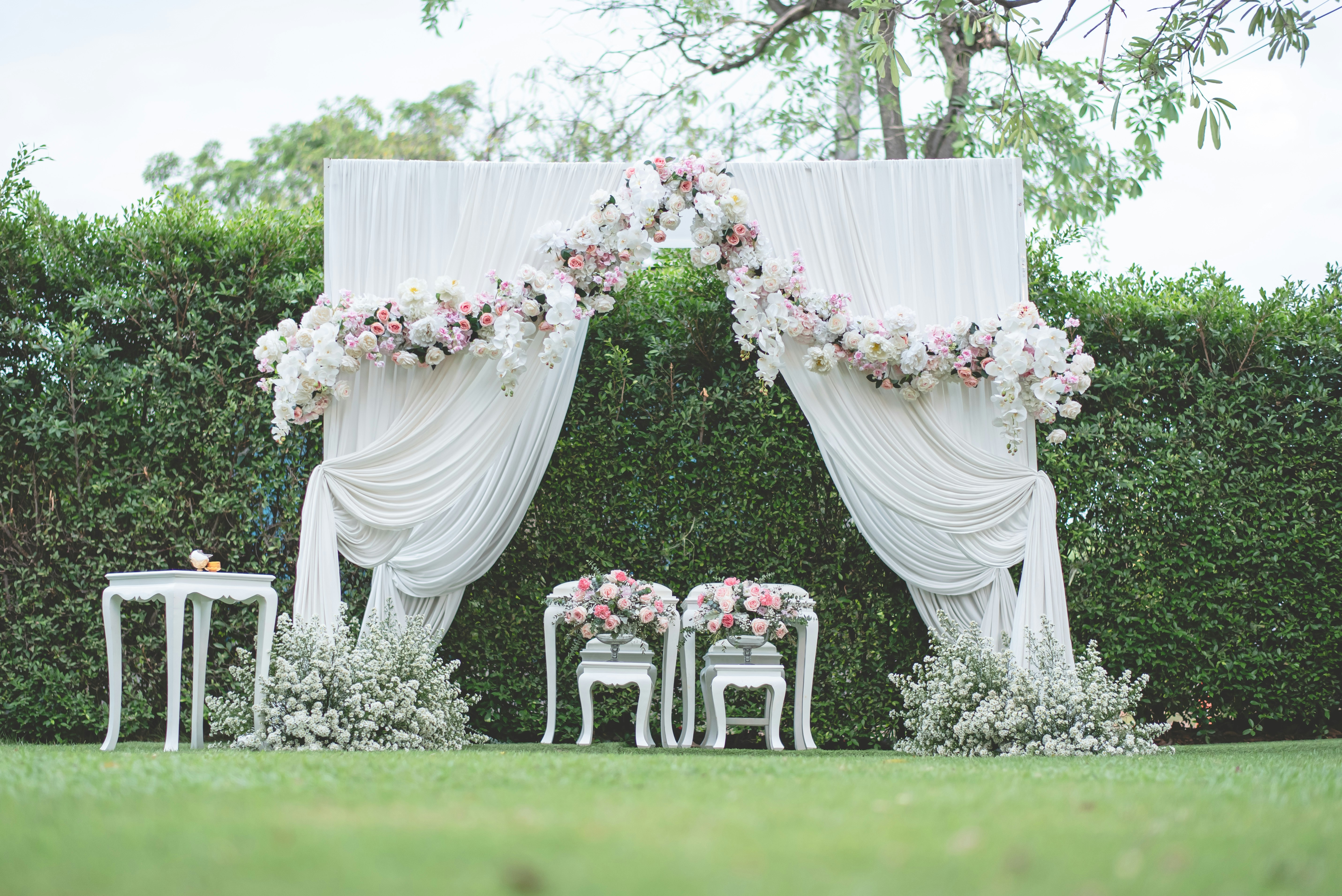 white and pink flower bouquet on white wooden armchair