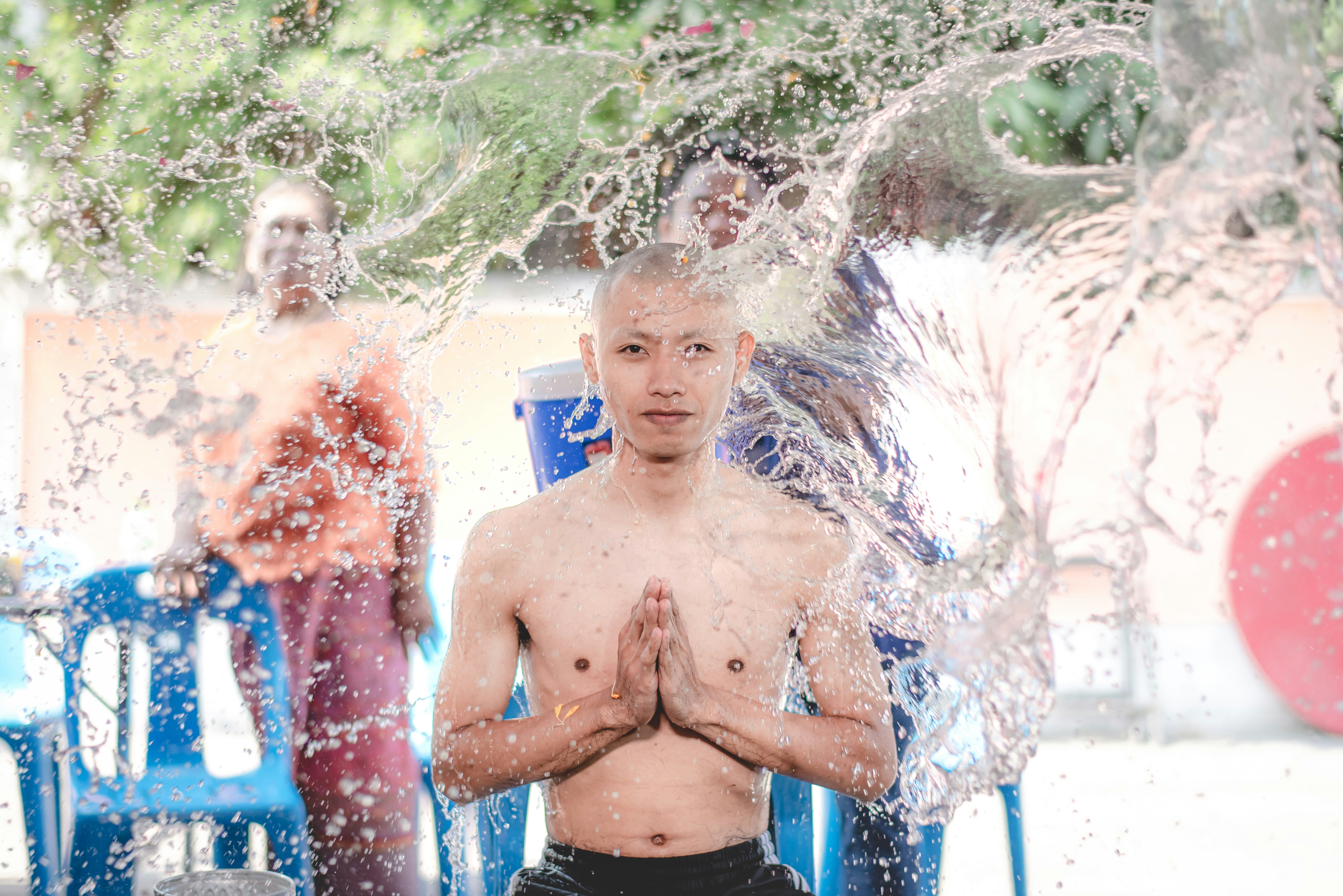 2 boys in blue shorts standing on water