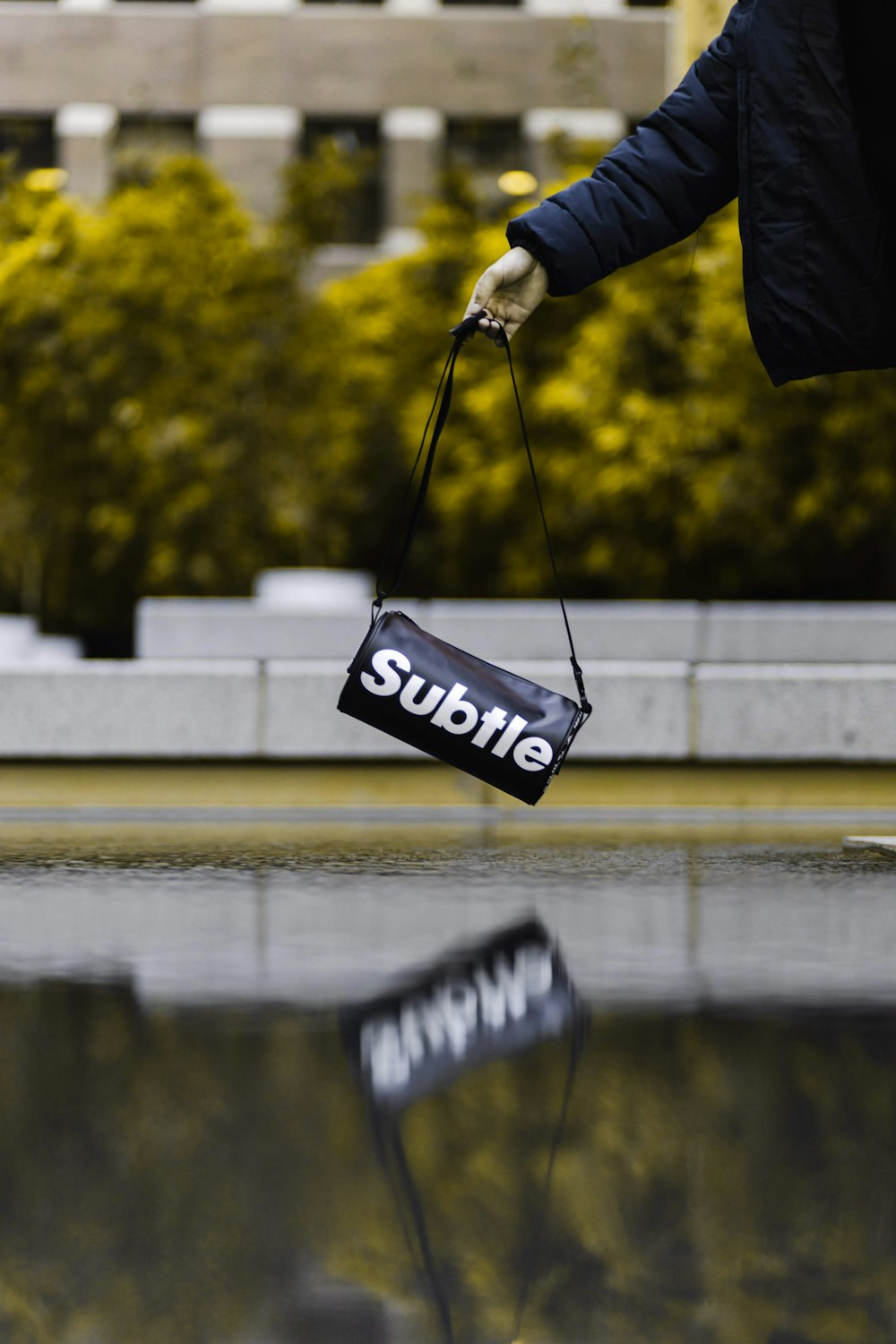 a person is holding a subbie bag in the rain