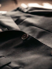 gray button up shirt with black button