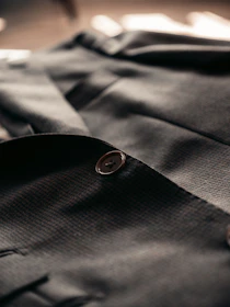 gray button up shirt with black button