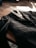 A close-up of a neatly folded tailored suit on a wooden table.