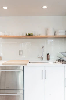 Close-up of a modern kitchen setup featuring premium stainless steel cookware and minimalist utensils.