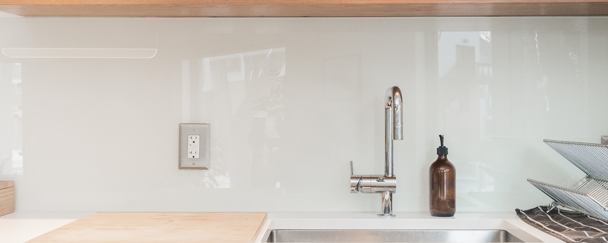 white ceramic plates on white wooden kitchen cabinet