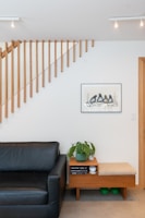 A modern wooden room divider in a bright living room.