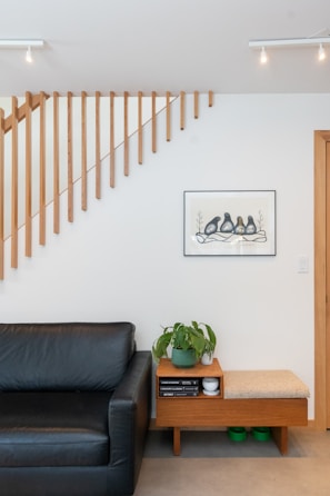 A modern wooden room divider in a bright living room.