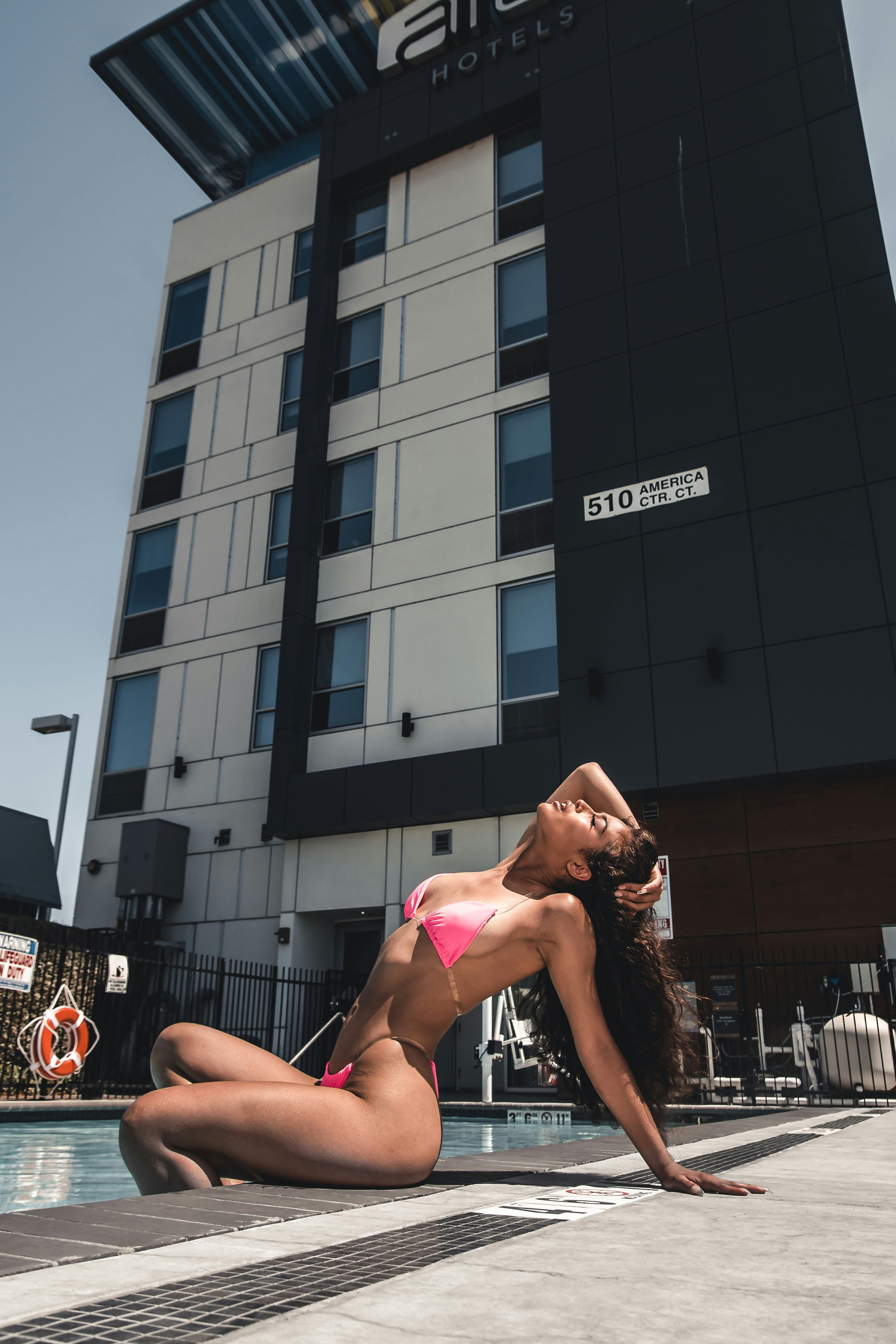 woman in pink bikini lying on basketball court