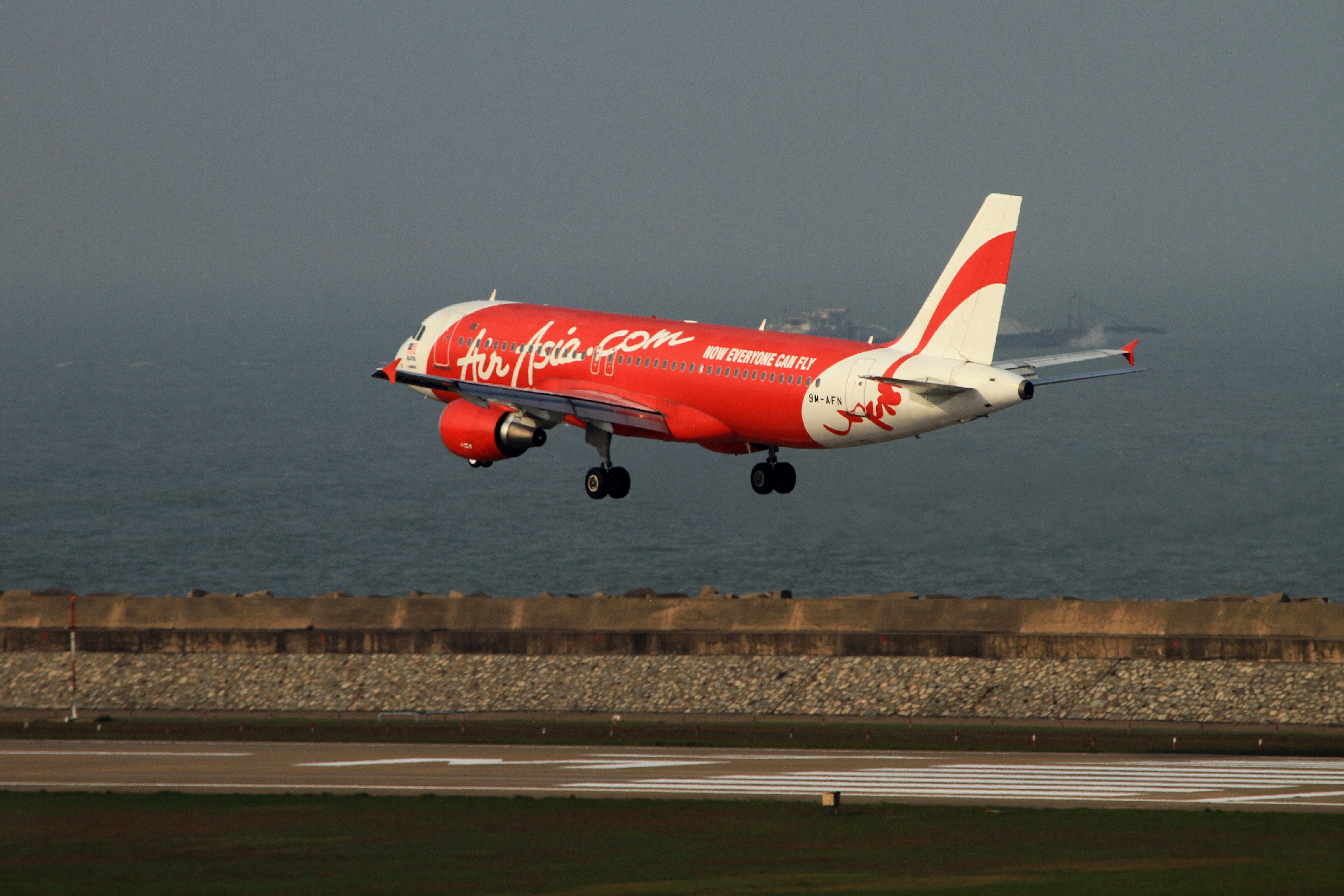 red and white airplane on airport during daytime