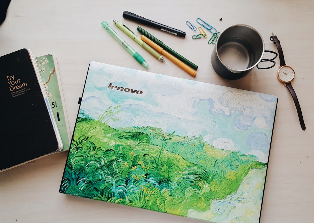 green and white floral book beside white pen and white and black pen, Van Gogh touch to my laptop ?