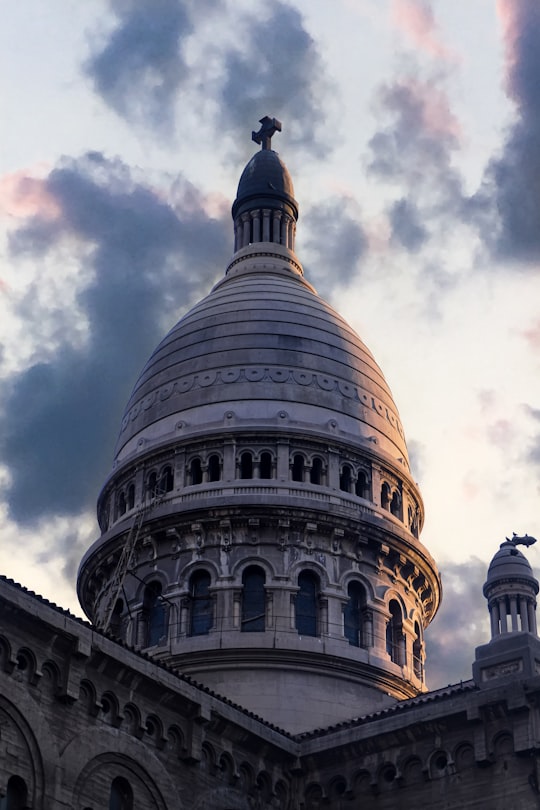 gray concrete dome building under white clouds during daytime in Iglesia de los Sacramentinos - Santa Isabel Chile