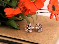A selection of vibrant gemstone earrings showcased against a light background.