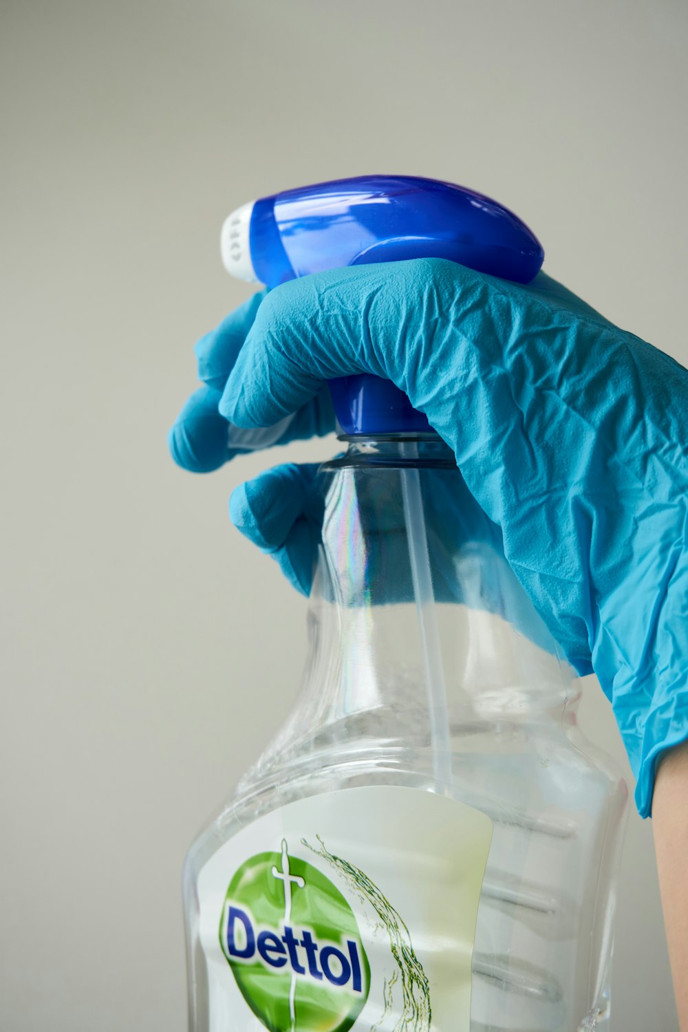 person holding clear glass bottle