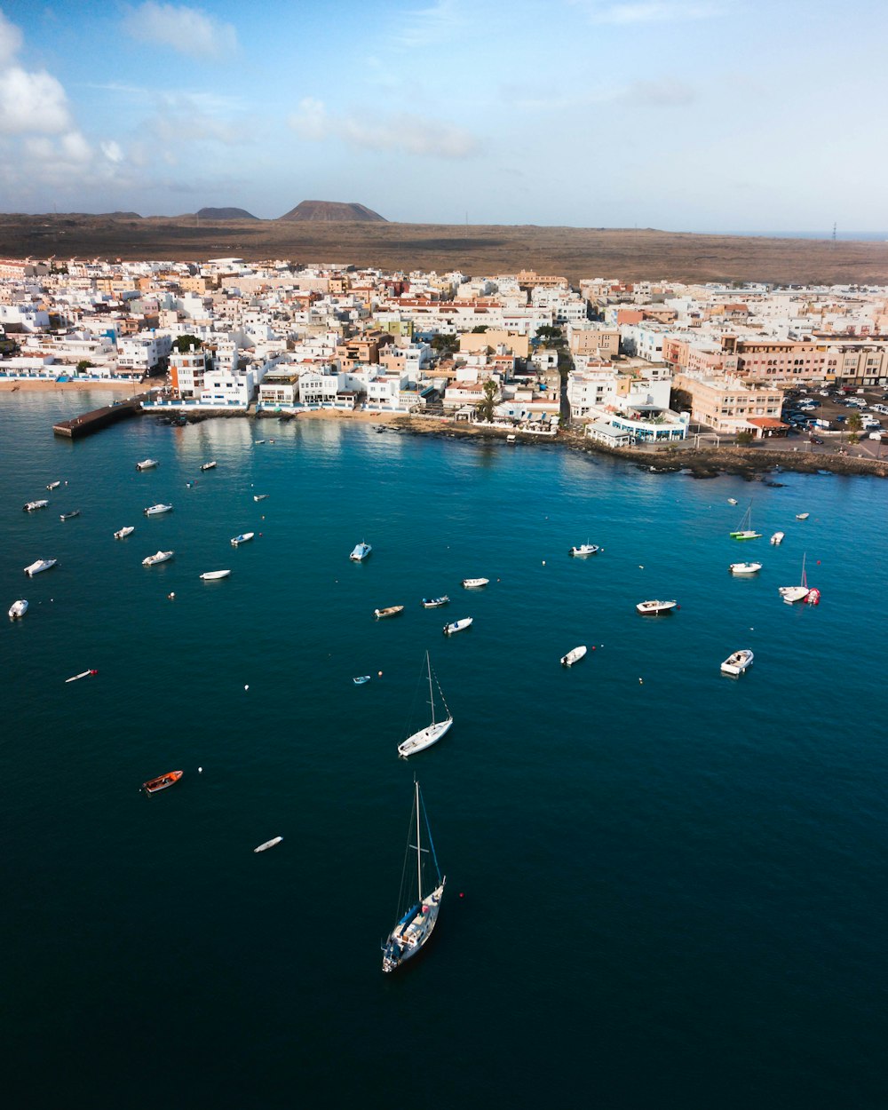 aerial view of boats on sea near city during daytime