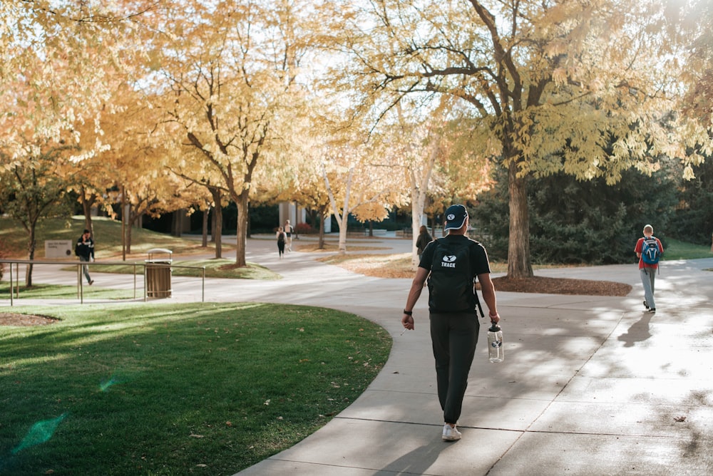 man in black t-shirt and black pants riding on black skateboard during daytime