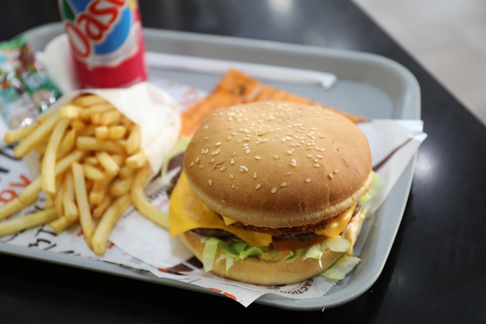 burger with fries on white paper