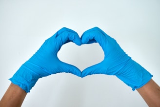 A medical professional making a heart sign with his hands