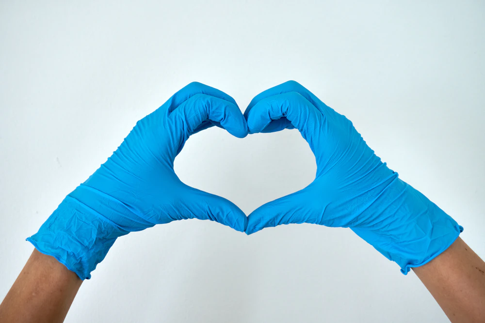 Gloved hands forming a heart — cleaning with care for the environment