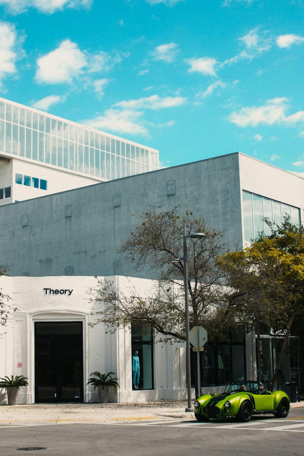 white concrete building near green trees during daytime