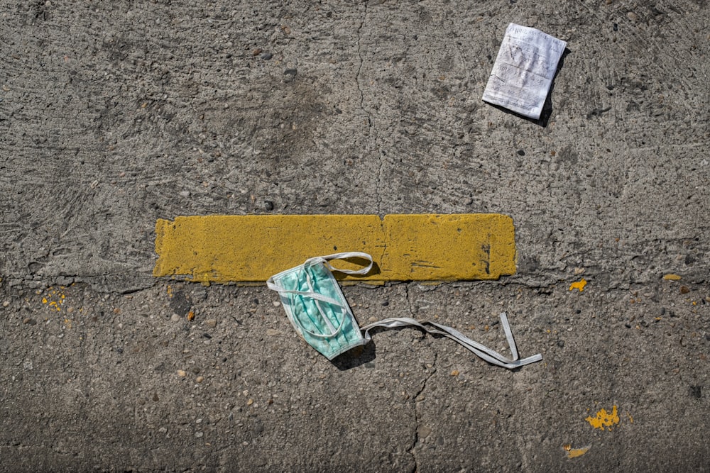 green and white plastic pack on brown concrete floor