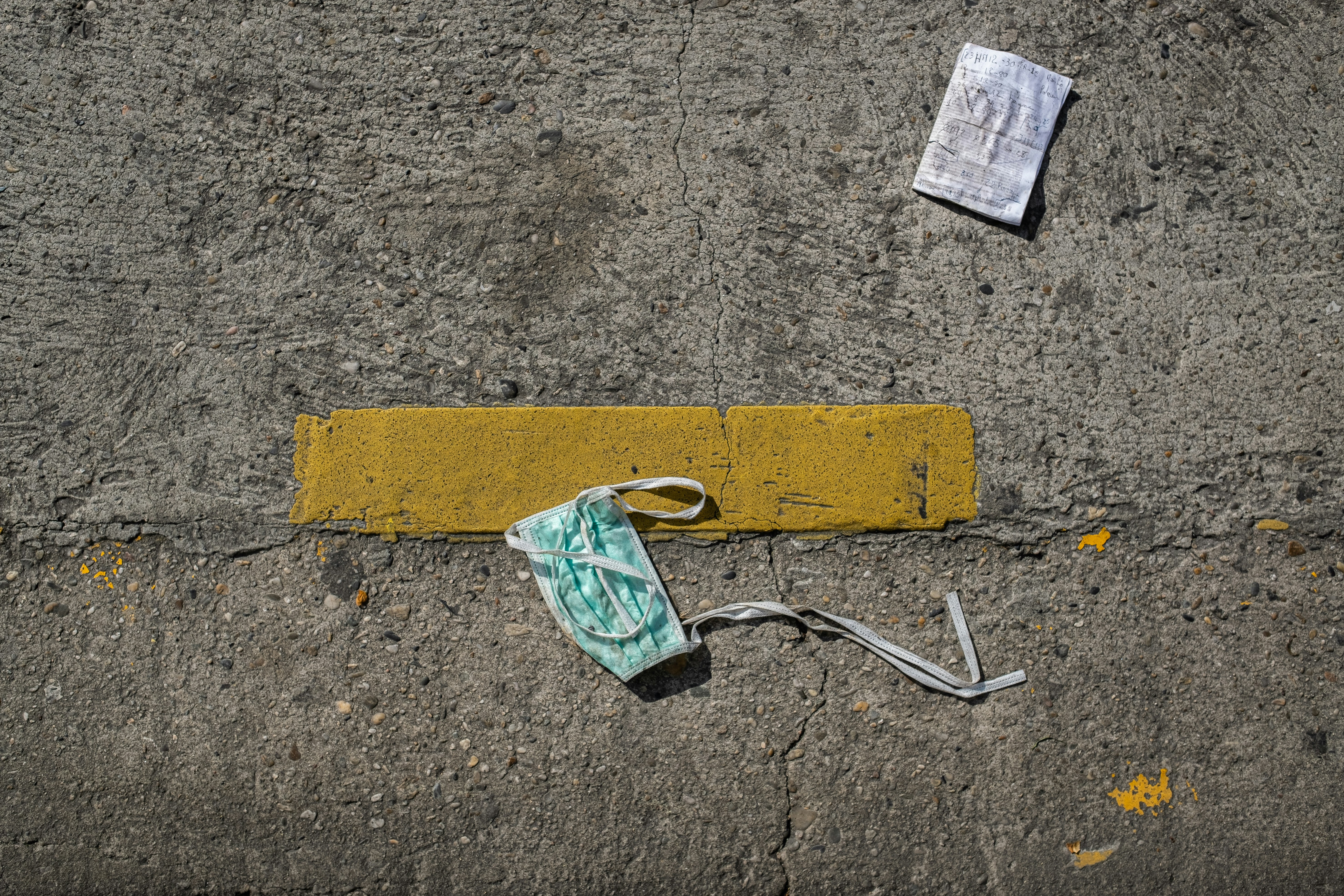 green and white plastic pack on brown concrete floor