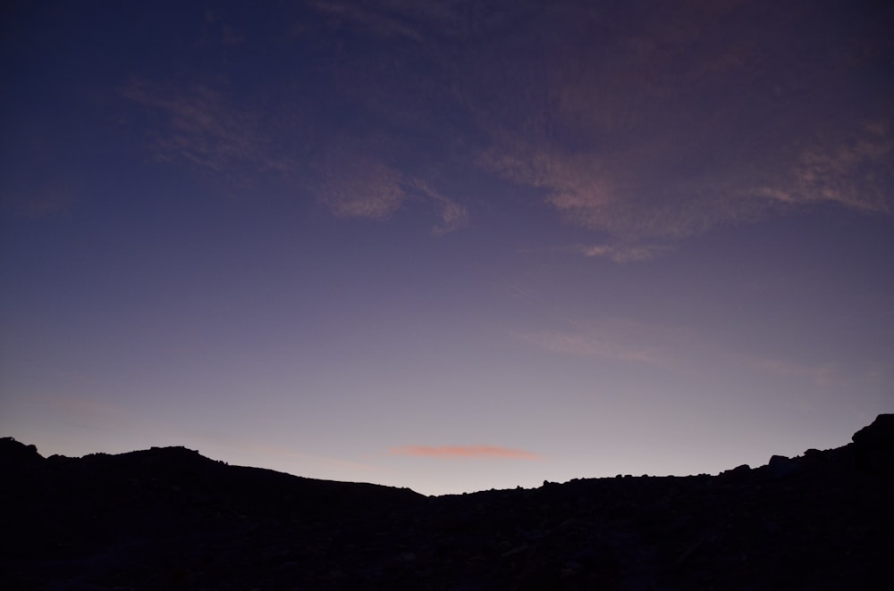 silhouette of mountain under blue sky during sunset