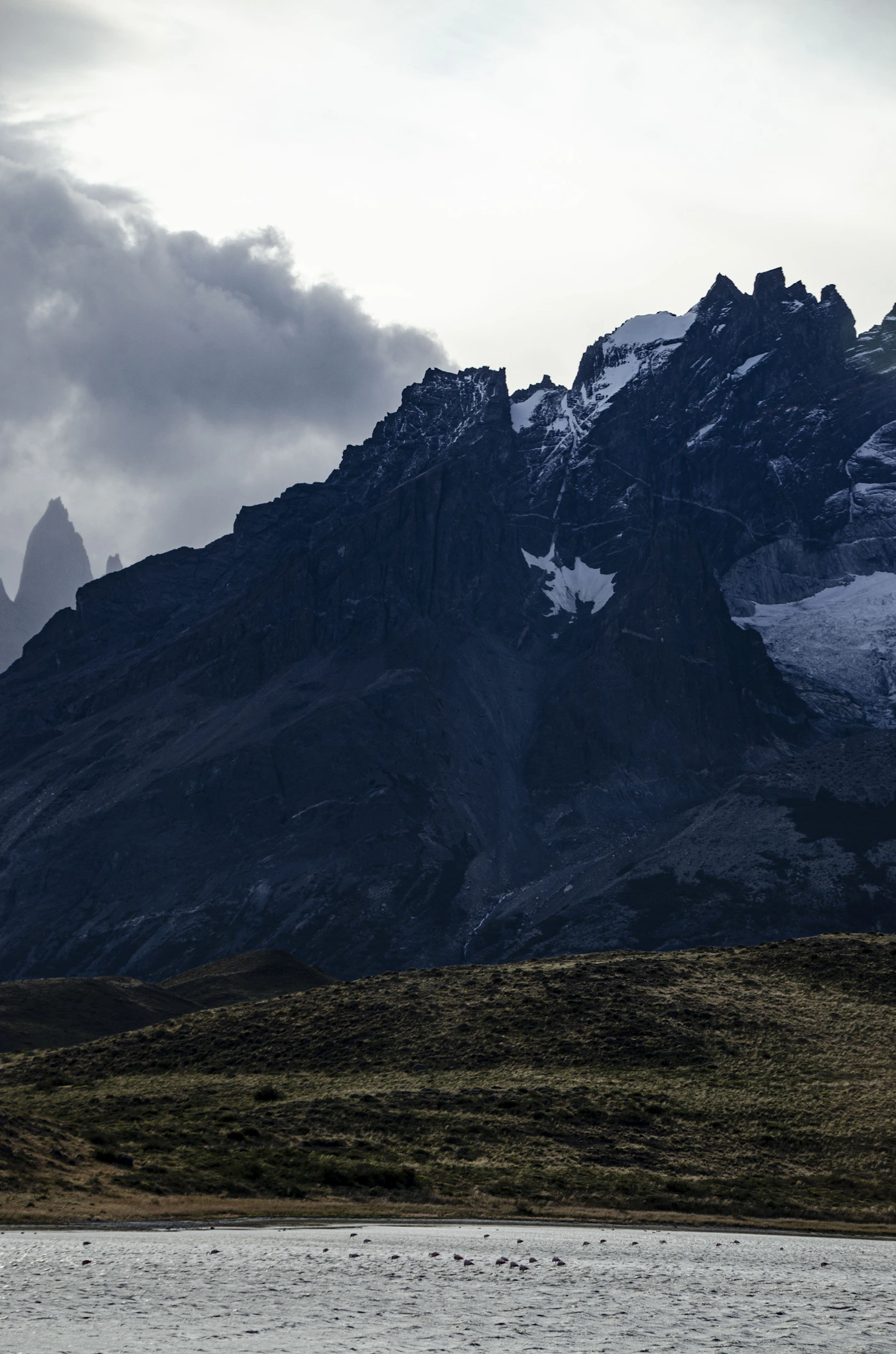 W Trek trail through Torres del Paine with dramatic mountain scenery and glaciers visible during multi-day approach to the towers