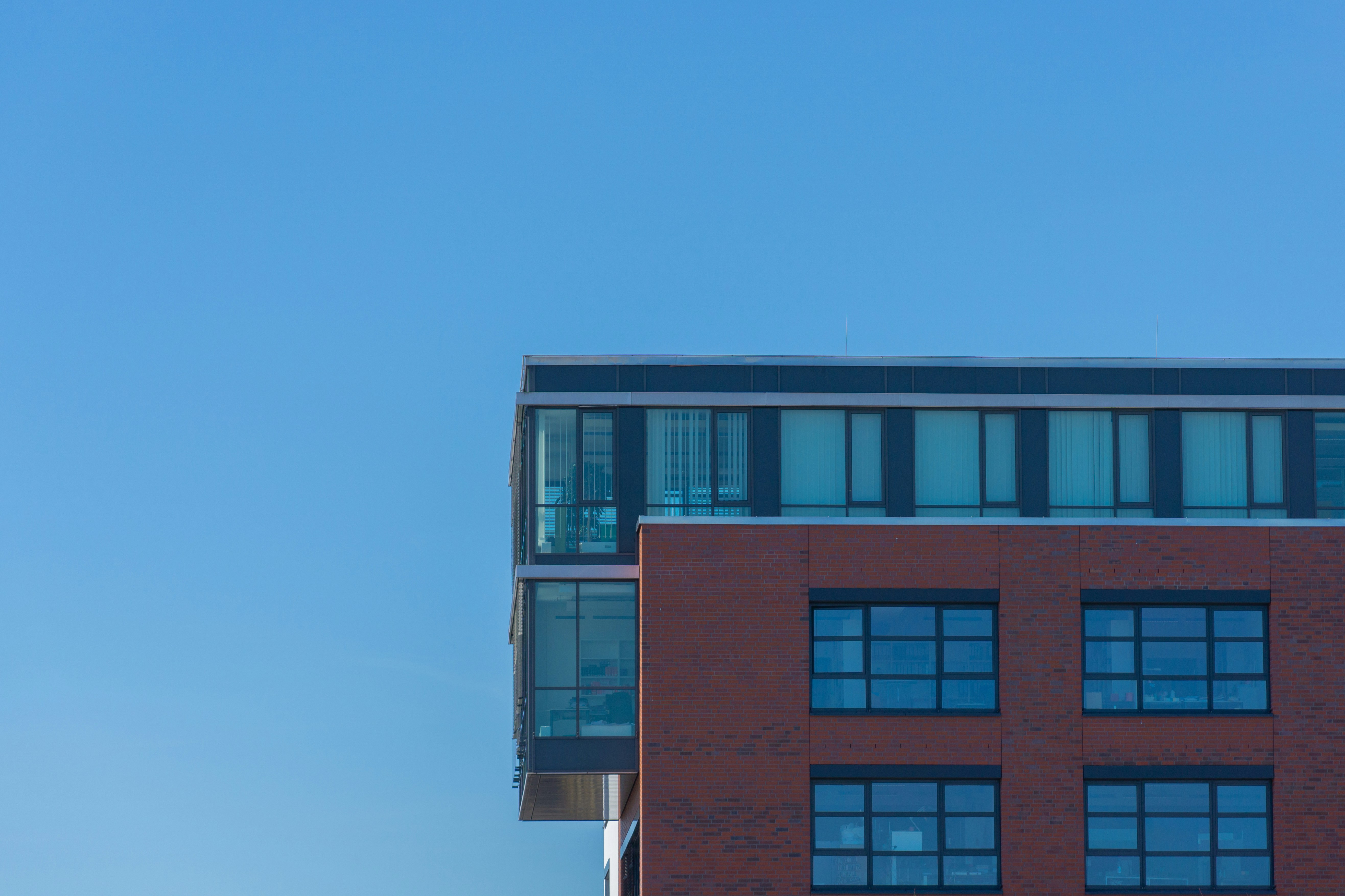 brown and white concrete building under blue sky during daytime, Brick on blue