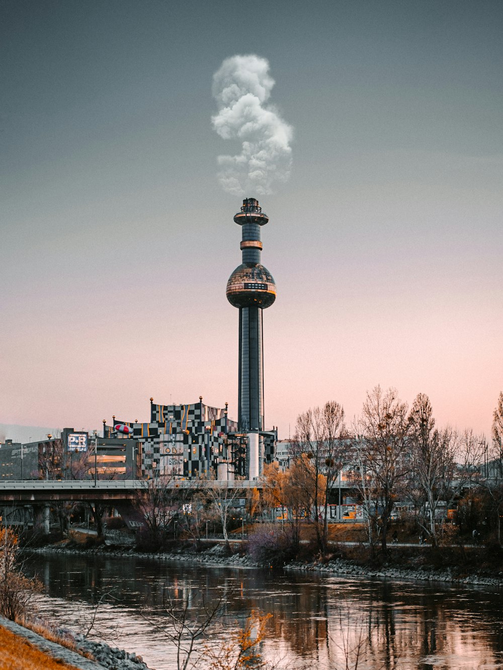 white and black tower near body of water during daytime