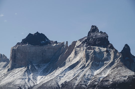 snow covered mountain under blue sky during daytime in Torres del Paine National Park Chile