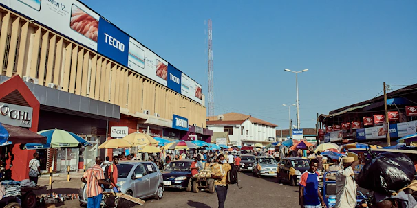 A vibrant street scene showing people exchanging job offers on their phones.