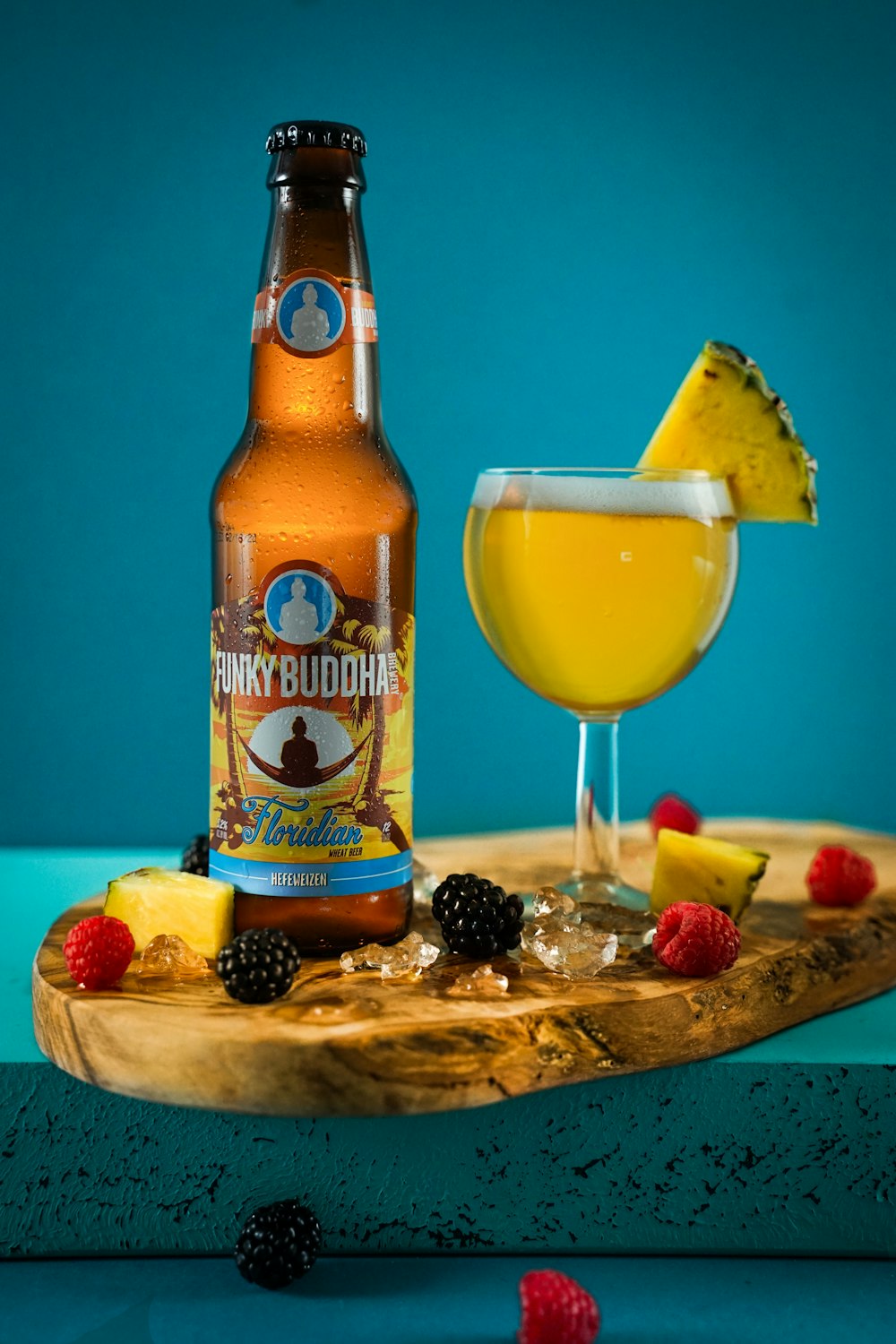 brown glass bottle beside clear drinking glass with yellow liquid