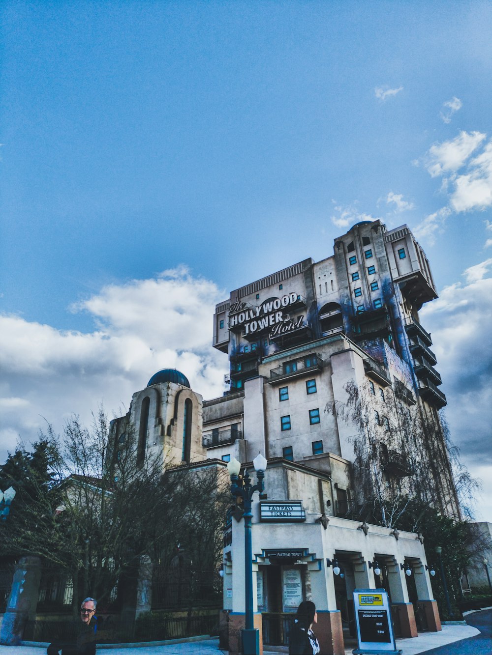 low angle photography of concrete building under blue sky during daytime