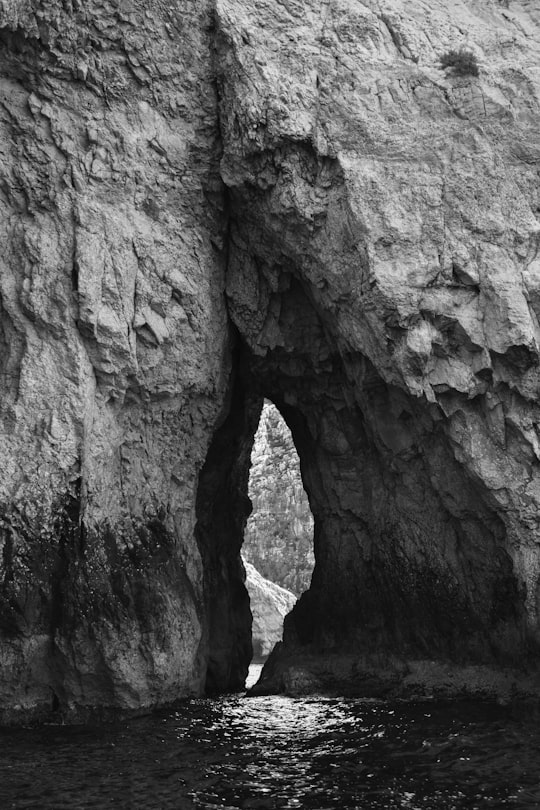 grayscale photo of rock formation in Blue Grotto Malta