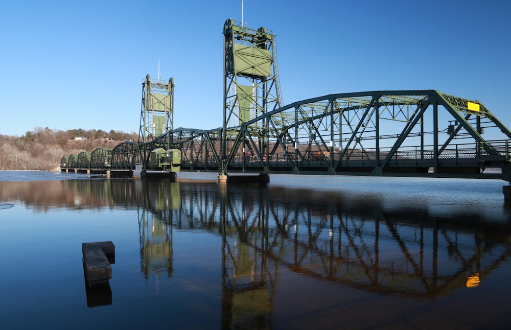 gray metal bridge over river during daytime