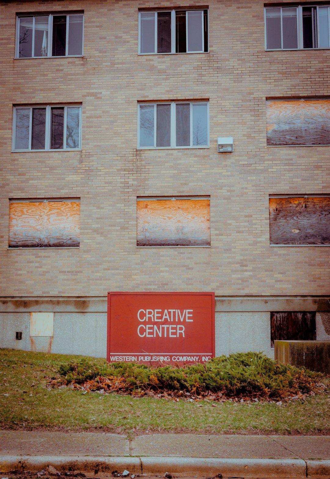 brown brick building with red and white signage