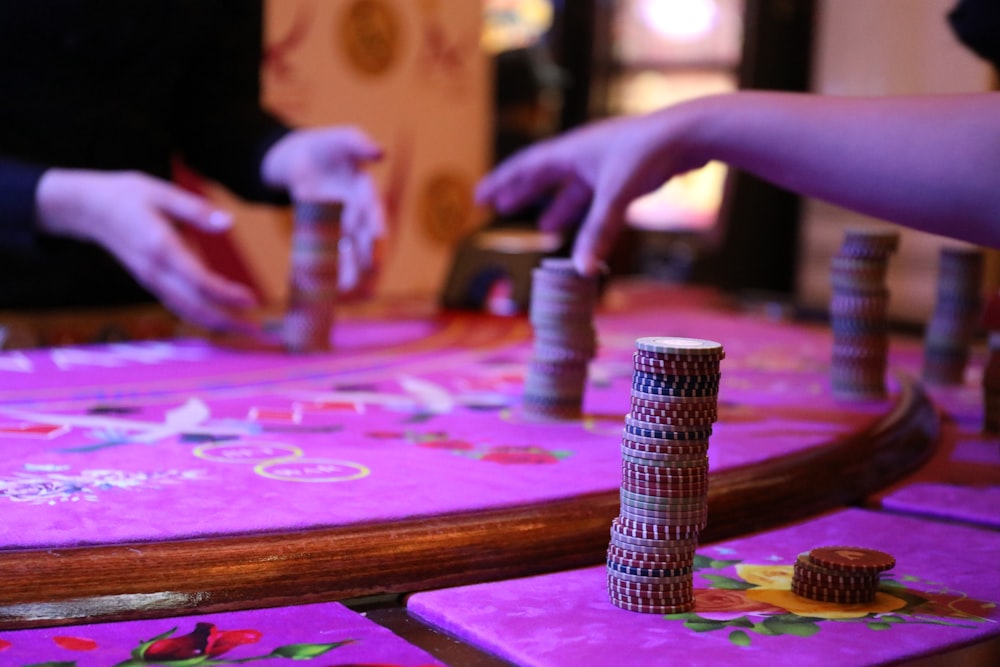 silver and black tube on pink and purple table cloth