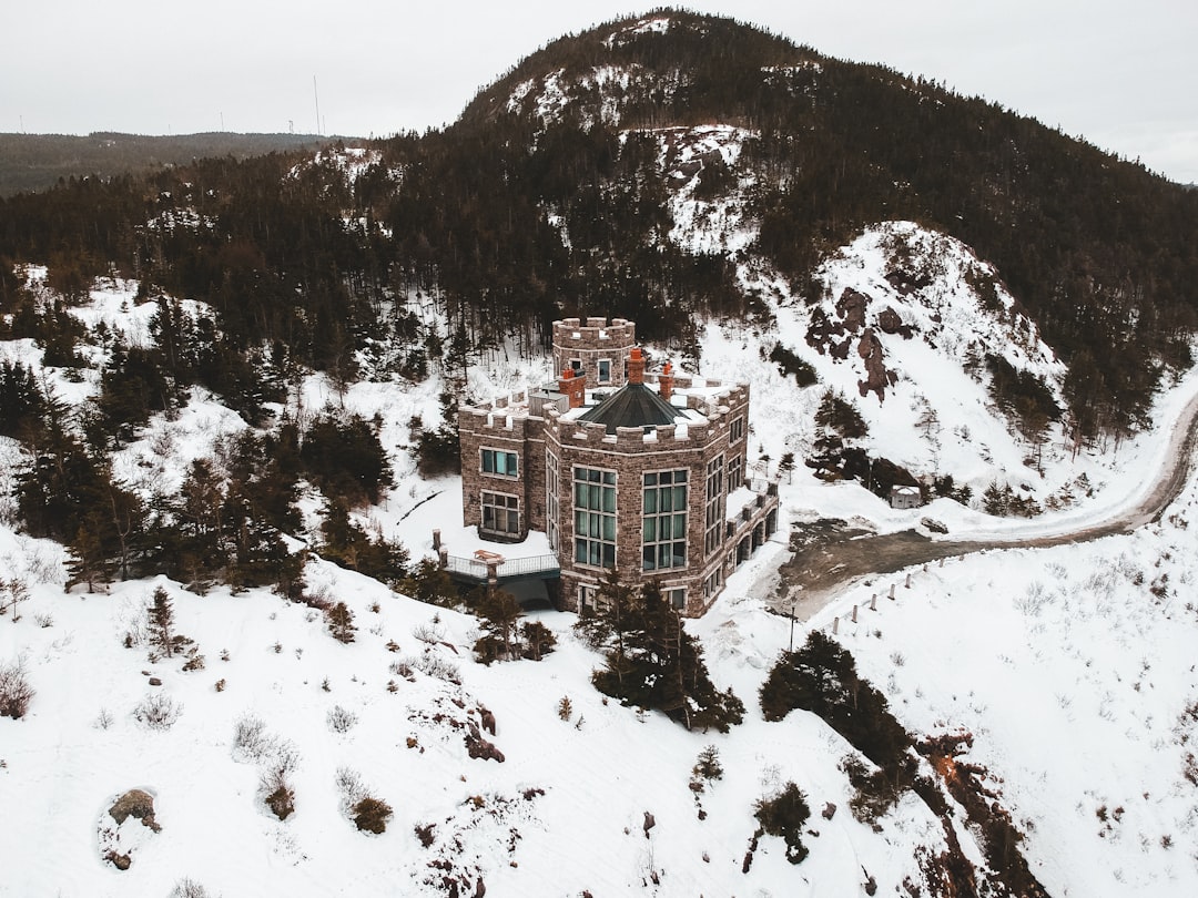 brown and white concrete building on snow covered ground