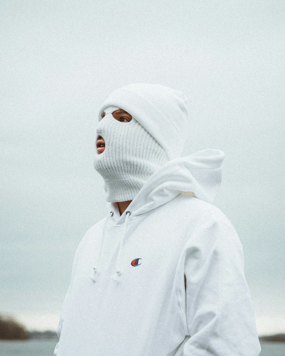 person in white hoodie wearing white knit cap