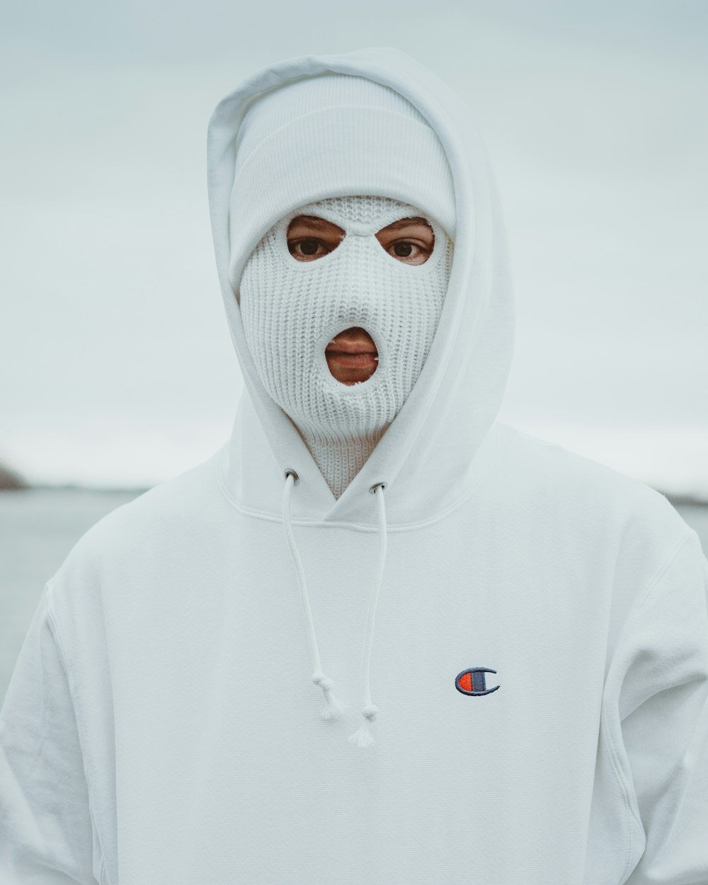person in white hoodie with white mask
