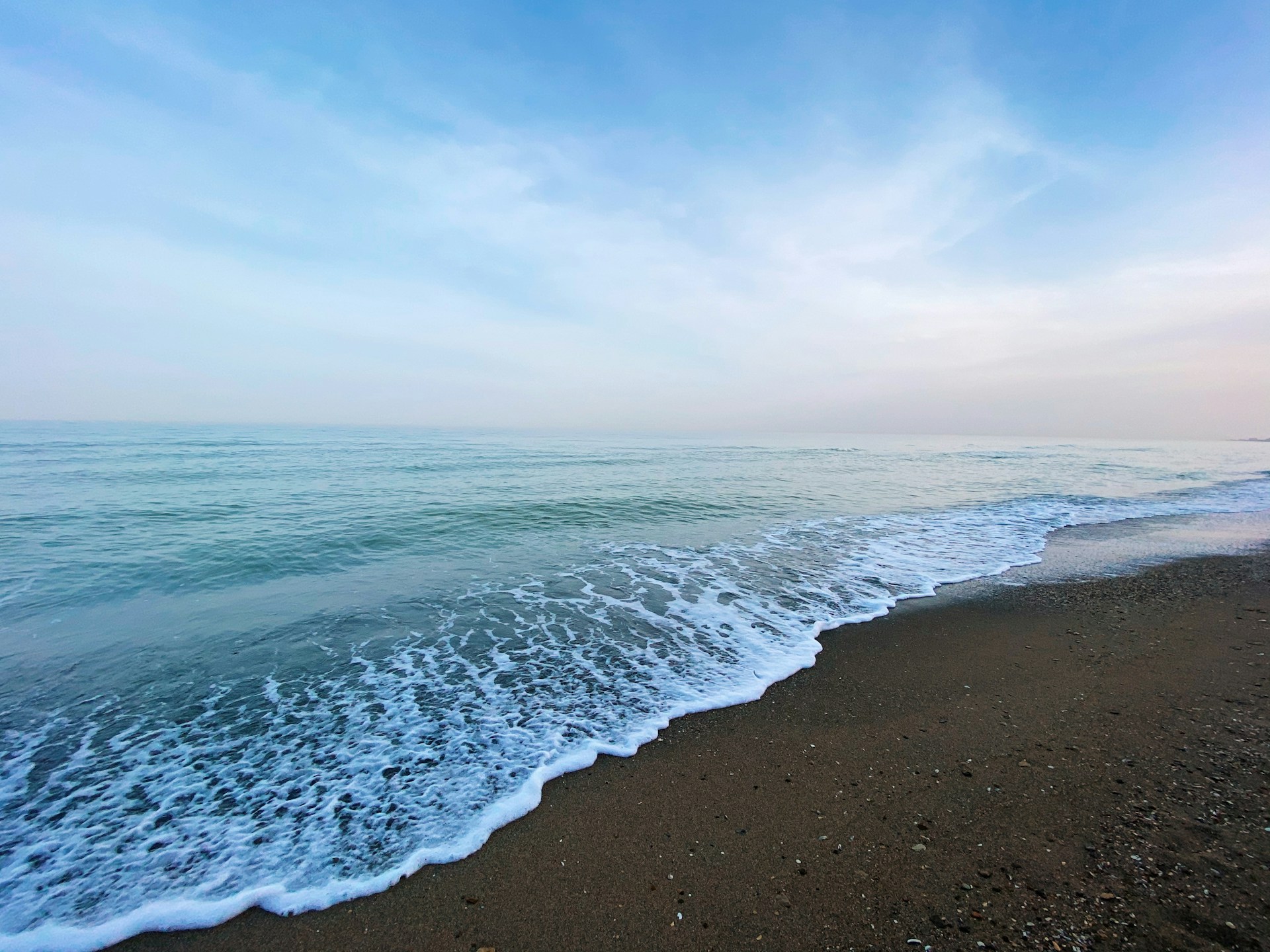 woman wearing yellow long-sleeved dress under white clouds and blue sky during daytime